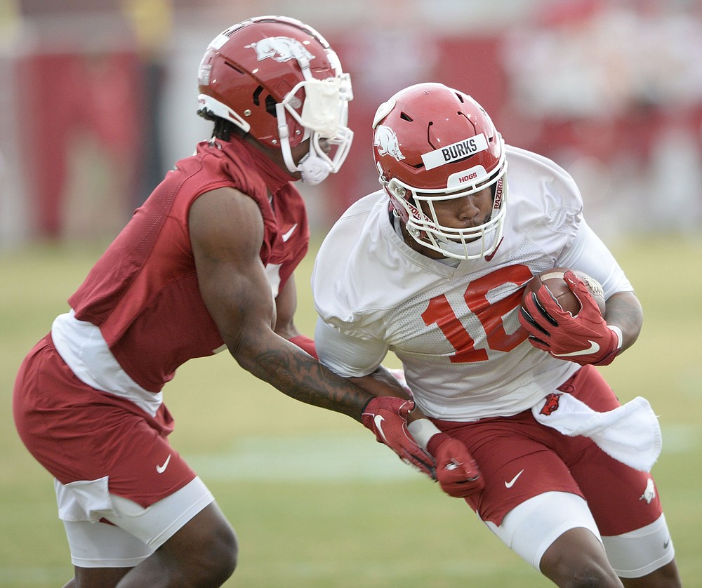 Treylon Burks (right), who had a team-leading 51 receptions for 820 yards and 7 touchdowns in 9 games last year, said he is looking to become faster this season and is making strides toward reaching his weight goals. (NWA Democrat-Gazette/Andy Shupe)