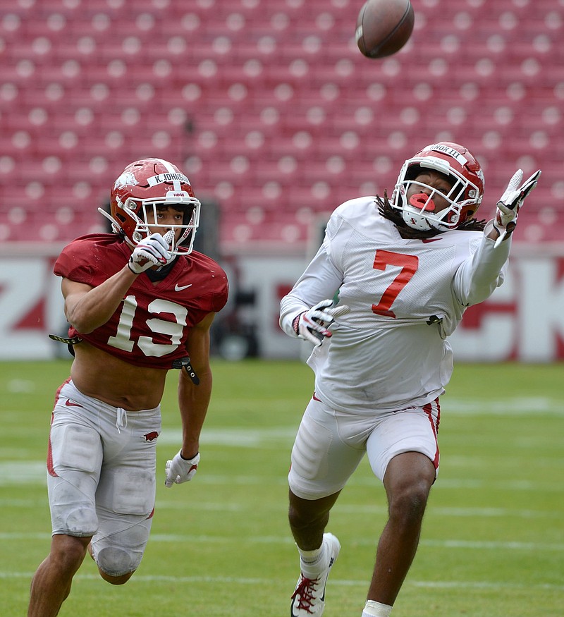 Trey Knox (7) reaches to make a catch ahead of Khari Johnson during an Arkansas scrimmage earlier this month. Knox, a 6-5, 210-pound junior, is aiming to have a better season than he had in 2020 when he caught seven passes for 70 yards and did not score a touchdown.
(NWA Democrat-Gazette/Andy Shupe)