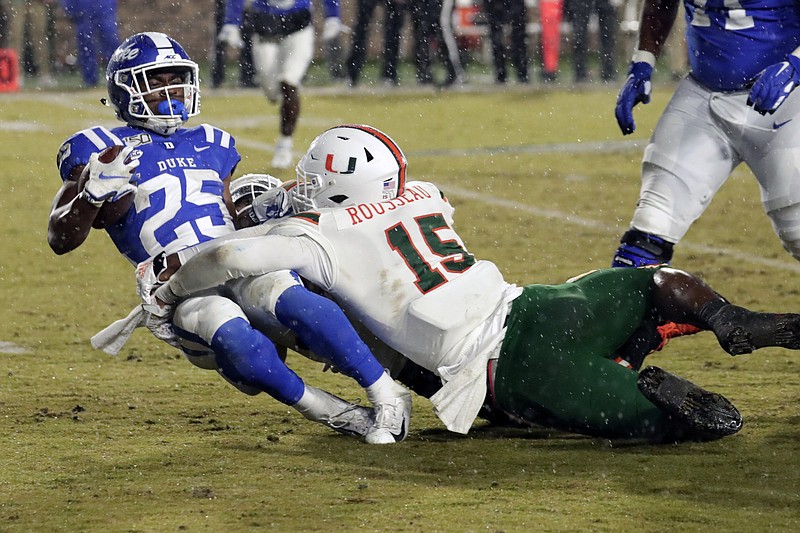 Miami’s Gregory Rousseau (right) brings down Duke’s Deon Jackson during a November 2019 game. Rousseau is among at least a half-dozen first-round draft hopefuls who sat out all of 2020, leaving front offices to consider the risks and rewards of selecting someone who played last year vs. someone who didn’t.
(AP file photo)