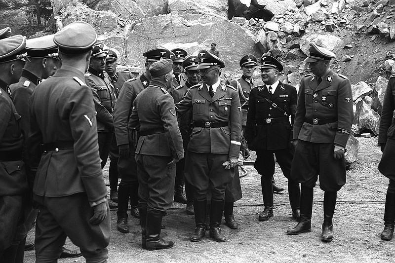 Franz Josef Huber (sixth from right at center rear) accompanies SS leader Heinrich Himmler (fourth from right) during a visit to the Mauthausen concentration camp in Austria where at least 90,000 internees were murdered.
(The New York Times/Amical de Mauthausen)