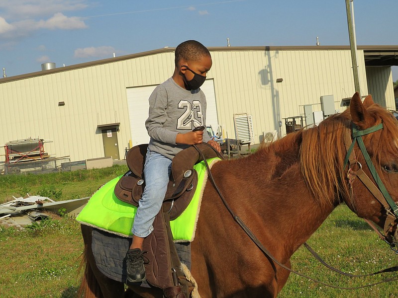 Kyiler King takes a ride on a horse named Milkshake. 
(Special to The Commercial/Carmen Bailey, administrative specialist for UAPB)