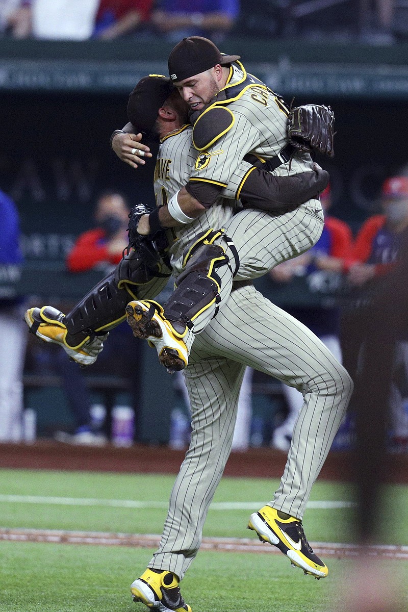 San Diego Padres catcher Victor Caratini (right) celebrates with pitcher Joe Musgrove after Musgrove’s no-hitter against the Texas Rangers on Friday night at Globe Life Field in Arlington, Texas. Caratini is the first MLB catcher to be behind the plate for consecutive no-hitters in the league for different teams. He caught Alec Mills’ no-hitter Sept. 13 for the Chicago Cubs against the Milwaukee Brewers.
(AP/Richard W. Rodriguez)