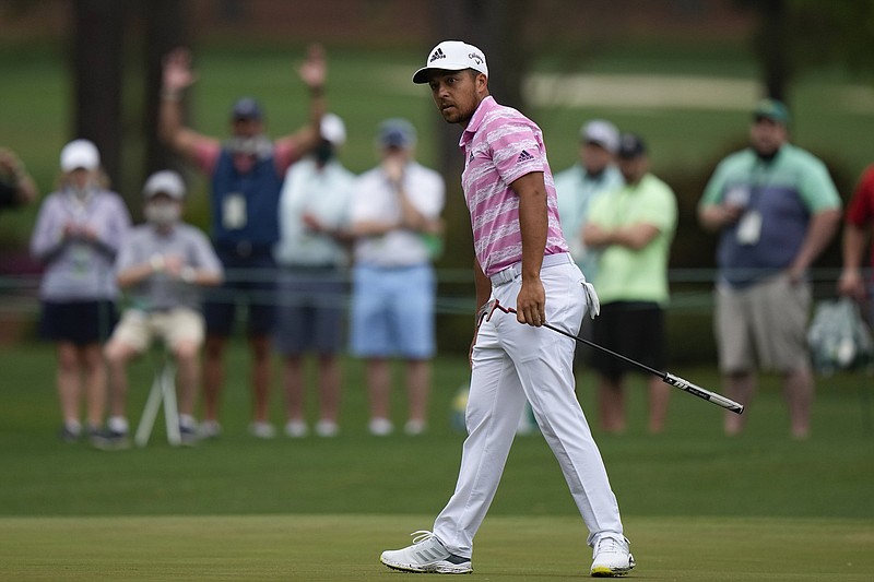 Xander Schauffele watches as his ball goes in for an eagle on the 15th hole during the third round of the Masters on Saturday in Augusta, Ga. Schauffele shot a third-round 68 and is in a four-way tie for second place entering today’s final round.
(AP/Matt Slocum)