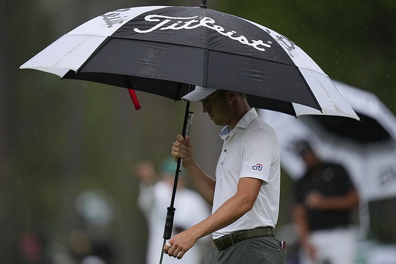 Justin Thomas protects himself from the rain as he walks on the 15th hole Saturday at Augusta National Golf Club in Augusta, Ga. Saturday’s third round was delayed 1 hour, 18 minutes because of severe weather in the area.
(AP/Matt Slocum)