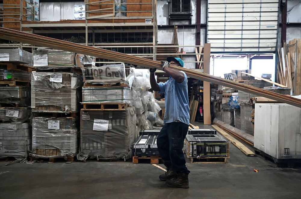 Khiry Smith carries a load of lumber through the warehouse during his shift at Lumber One in Mayfl
ower on Tuesday. See more photos at arkansasonline.com/411lumber/.
(Arkansas Democrat-Gazette/Stephen Swofford)