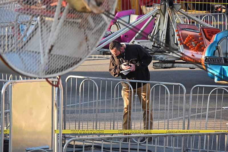 The Little Rock Police Department investigates a shooting Saturday, April 10, 2021 at the Outlets of Little Rock Carnival in the shopping mall's parking lot. (Arkansas Democrat-Gazette/Staci Vandagriff)