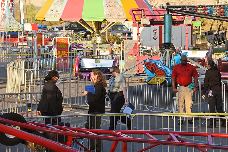 The Little Rock Police Department investigates a shooting on Saturday, April 10, 2021, at the Outlets of Little Rock Carnival in the mall's parking lot. (Arkansas Democrat-Gazette/Staci Vandagriff)