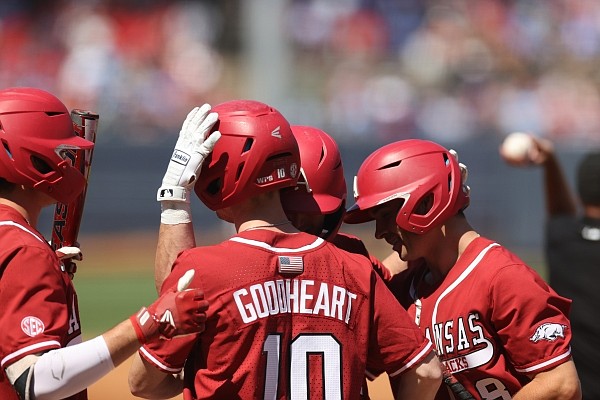 Arkansas' Matt Goodheart celebrates with teammates after scoring a run during the Razorbacks' 18-14 win over Ole Miss in Game 3 of the series on Sunday in Oxford, Miss. (SEC Pool)