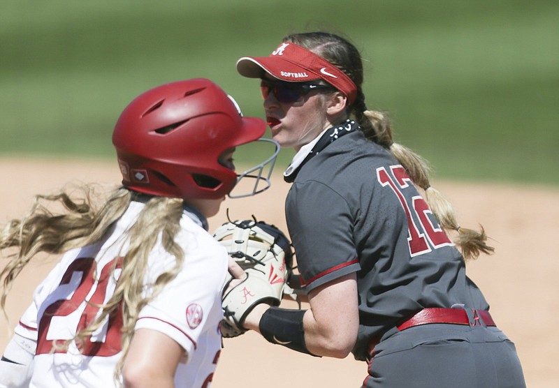 Alabama infielder Kaylee Tow (12) tags out Arkansas Hannah Gammill (20), Sunday, April 11, 2021 during the fifth inning of a softball game at Bogle Park in Fayetteville. Check out nwaonline.com/210412Daily/ for today's photo gallery. .(NWA Democrat-Gazette/Charlie Kaijo)
