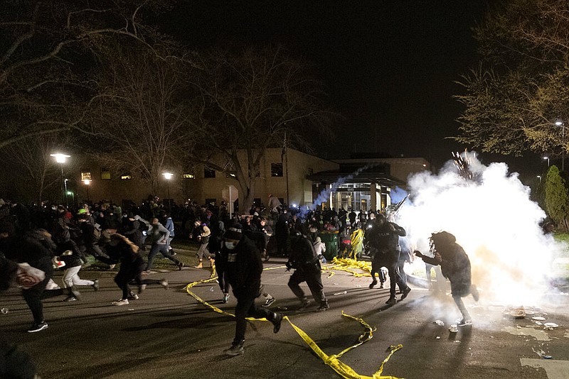 People run as police attempt to disperse the crowd at the Brooklyn Center Police Department, late Sunday, April 11, 2021, in Brooklyn Center, Minn. The family of Daunte Wright, 20, told a crowd that he was shot by police Sunday before getting back into his car and driving away, then crashing the vehicle several blocks away. The family said Wright was later pronounced dead. (Carlos Gonzalez/Star Tribune via AP)