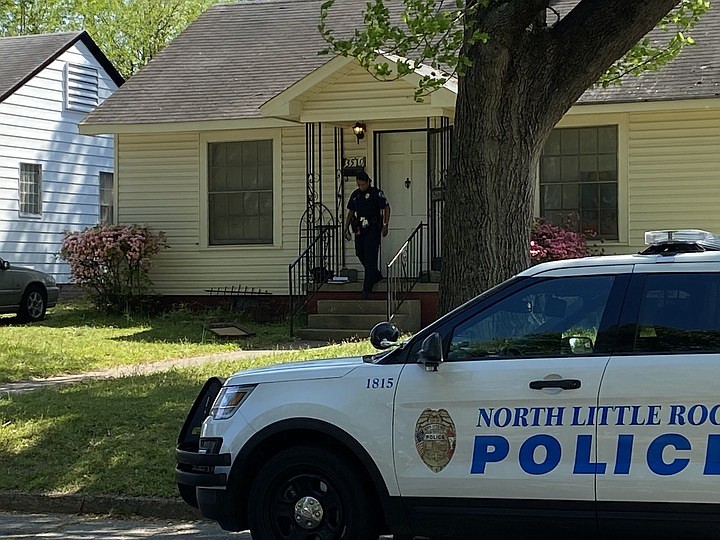 An officer walks near a North Little Rock residence where a person was barricaded on Tuesday morning. (Arkansas Democrat-Gazette/Brianna Kwasnik)