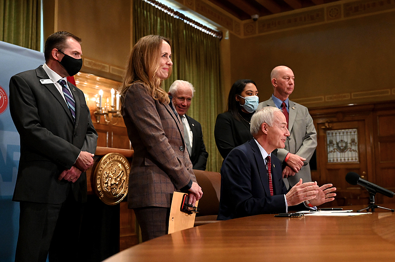 Governor Hutchinson, surrounded by legislators and teachers from Arkansas, signs teacher salary bills SB504 and HB1614 during a press conference at the Arkansas State Capitol on Monday, April 12, 2021. The bills will increase the target median salary for teachers to $52,822, an increase of $2,000, Hutchinson said. (Arkansas Democrat-Gazette/Stephen Swofford)