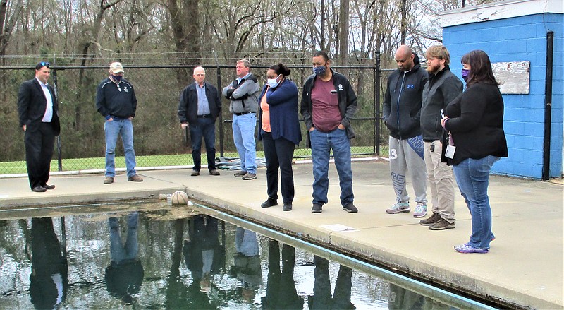 Inspectors from the Arkansas Department of Health take a look at the Mattocks Park swimming pool during a walk-through with the El Dorado Parks and Playgrounds Commission. From left, Commissioner Greg Harrison; Commissioner David Hurst; EPPC chairman Ken Goudy; Robert Edmonds, El Dorado director of public works; Donna Johnson, environmental health specialist for the ADH; Ray Johnson, manager of the swimming pool and former El Dorado sanitation supervisor; Commissioner and El Dorado City Council Member Andre Rucks; Cole Kitchens, pool program specialist for the ADH; and Commissioner Alexis Alexander. (Tia Lyons/News-Times)