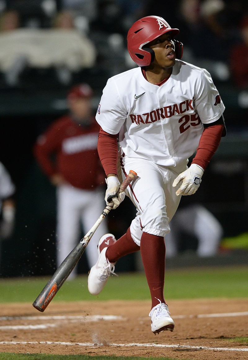 Arkansas center fielder Christian Franklin hits a three-run home run Tuesday, April 13, 2021, scoring left fielder Zac White and second baseman Robert Moore during the eighth inning of play against UAPB in Fayetteville. Visit nwaonline.com/210414Daily/ for today's photo gallery. .(NWA Democrat-Gazette/Andy Shupe)