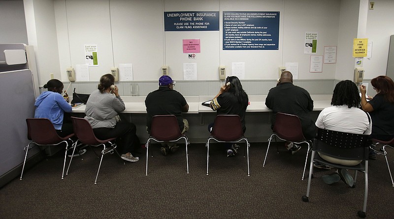 Visitors use the unemployment insurance phone bank at the California Employment Development Department office in Sacramento in this September photo. Two Senate Democrats on Wednesday announced a plan to overhaul the nation’s unemployment insurance system.
(AP)