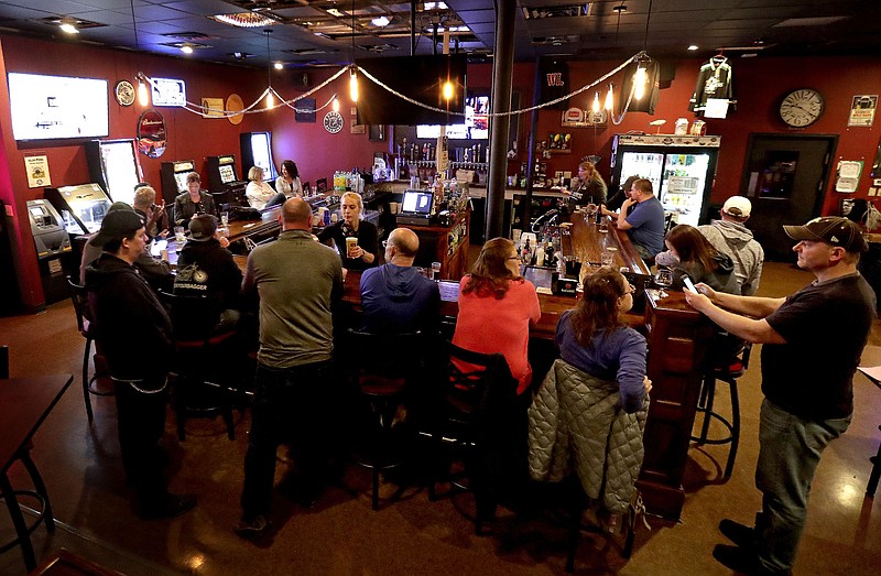 A crowd gathers at the Dairyland Brew Pub in Appleton, Wis., last May. There has not been a statewide capacity limit on bars, restaurants and other businesses since October, despite persistent increases in coronavirus cases.
(AP/The Post-Crescent/William Glasheen)