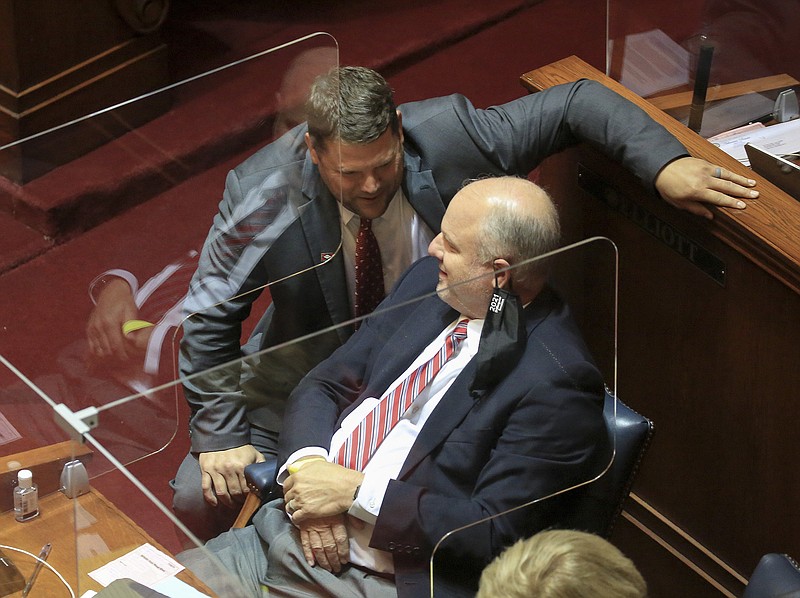 Sen. Bart Hester (left), R-Cave Springs, and Sen. Jim Hendren, I-Sulphur Springs, confer Wednesday on the floor of the Senate.
(Arkansas Democrat-Gazette/Staton Breidenthal)