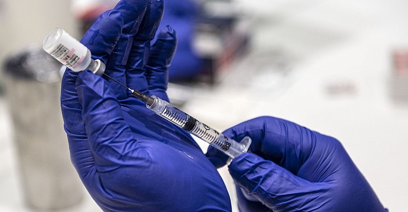 A syringe filled with Pfizer Covid-19 vaccine Thursday March 19, 2021. (NWA Democrat-Gazette File Photo/Spencer Tirey)