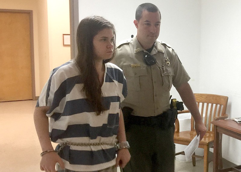 Andrea Lea Wilson, 26, of Bentonville is led into court in this May 23, 2018, file photo. (NWA Democrat-Gazette file photo)