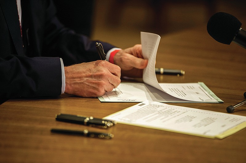 Governor Asa Hutchinson signs teacher salary bills on April 12, 2021 in this file photo. (Arkansas Democrat-Gazette/Stephen Swofford)