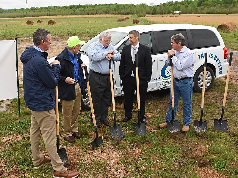 Tad Bohannon (center), CEO of Central Arkansas Water, talks with Cabot Mayor Ken Kincade (second from right) Wednesday during the groundbreaking ceremony for a solar plant at 1300 Richie Road in Cabot. Central Arkansas Water, the owner of the property, will lease it to Scenic Hill Solar.
(Arkansas Democrat-Gazette/Staci Vandagriff)