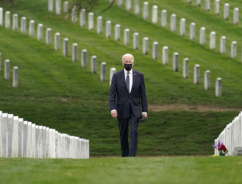 After announcing his plan Wednesday to pull all American forces out of Afghanistan, President Joe Biden walks through Arlington National Cemetery in recognition of U.S. troops who have died in recent conflicts. More photos at arkansasonline.com/415potus/.
(AP/Andrew Harnik)