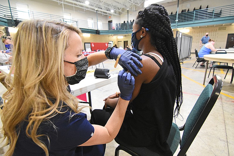 Whitney Campbell (left), a pharmacist for Express Rx at Otter Creek, gives Jassy Gray of Maumelle her second dose of the Pfizer coronavirus vaccine Thursday, April 15, 2021, at Henderson United Methodist Church in Little Rock. (Arkansas Democrat-Gazette/Staci Vandagriff)