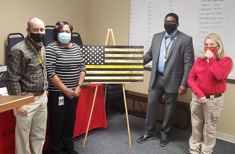 Maj. Gary McClain (from left), MECA Operations Manager Doris Golden, Sheriff Lafayette Woods Jr. and MECA Operations Director Karen Blevins observe National Public Safety Telecommunicators Week. 
(Special to The Commercial)