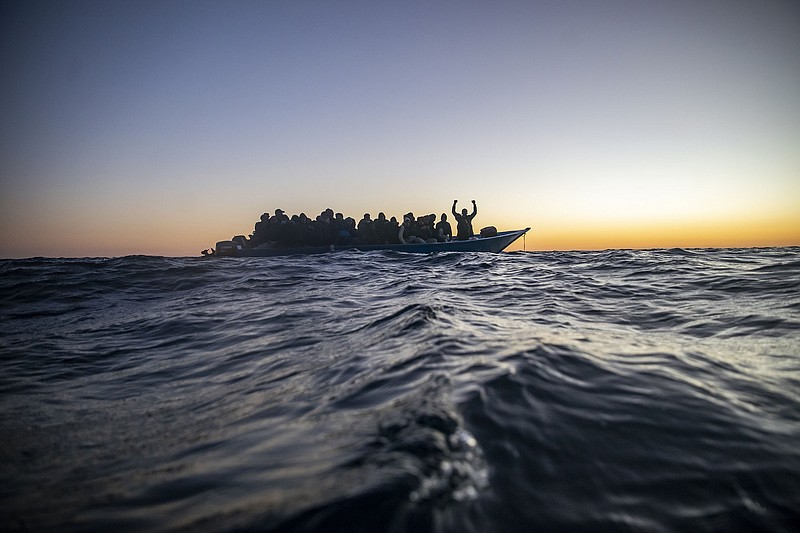 Migrants and refugees from African nations wait for assistance in February aboard a crowded wooden boat in the Mediterranean as aid workers of the Spanish NGO Open Arms approach.
(AP/Bruno Thevenin)