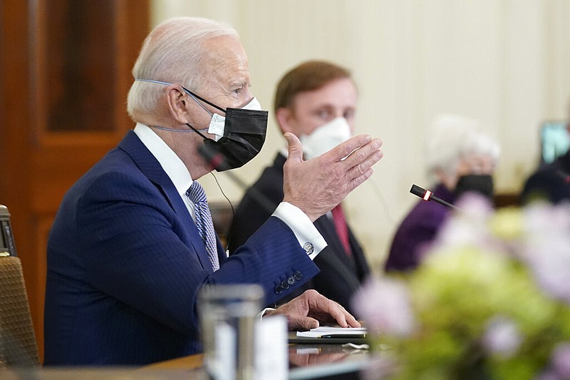 President Joe Biden speaks as he meets with Japanese Prime Minister Yoshihide Suga in the State Dining Room of the White House in Washington on Friday, April 16, 2021. Listening at right is national security adviser Jake Sullivan. (AP/Andrew Harnik)