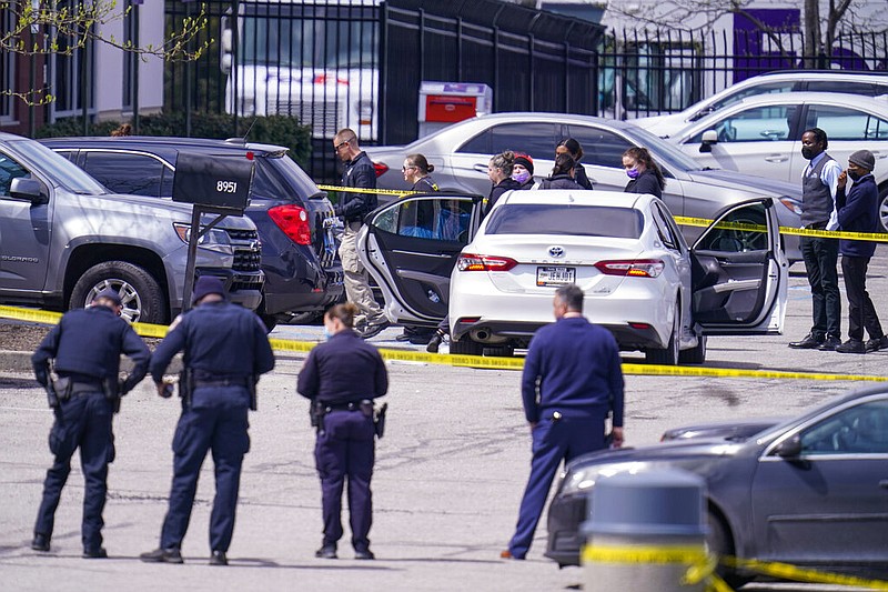 Law enforcement confer at the scene, Friday, April 16, 2021, in Indianapolis, where multiple people were shot at a FedEx Ground facility near the Indianapolis airport. (AP/Michael Conroy)