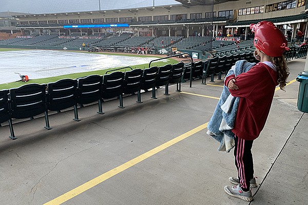 An Arkansas baseball fan looks on during a rain delay between Arkansas and Texas A&M on Friday, April 16, 2021, in Fayetteville.