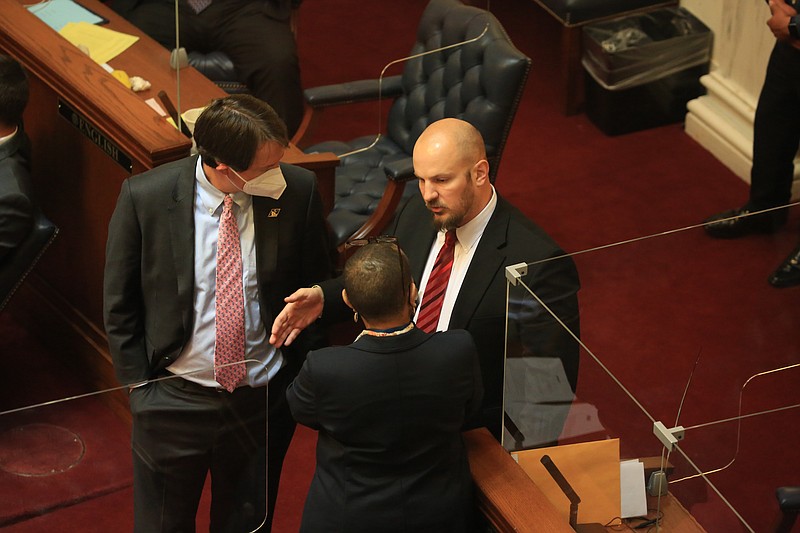 Sen. Trent Garner, right, R-El Dorado, talks Wednesday April 14, 2021 in the Senate chamber at the state Capitol with Sen. Clarke Tucker, left, D-Little Rock, and Sen. Joyce Elliott, D-Little Rock. (Arkansas Democrat-Gazette/Staton Breidenthal)