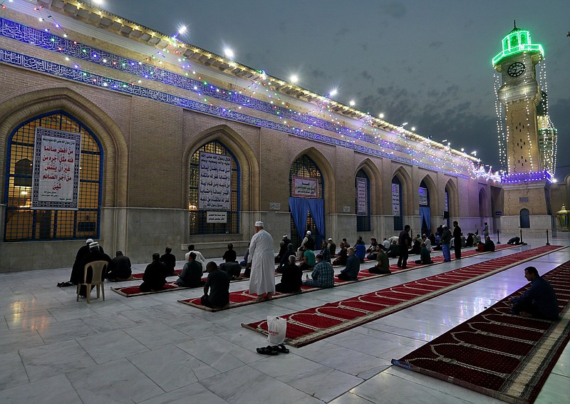 Muslims perform evening prayer at the Baghdad Sunni shrine of Abdul-Qadir al-Gailani on April 10, ahead of the Muslim fasting month of Ramadan. Many Muslim majority countries have been hit by an intense new coronavirus wave just as people prepared for the month of fasting, worship and charity that began Monday. While some countries imposed new Ramadan restrictions, concern is high that the month’s rituals could stoke another surge.
(AP/Khalid Mohammed)