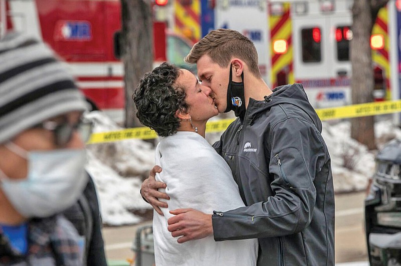 Maggie Montoya reunites with her boyfriend after being escorted by police out of King Soopers in Boulder Monday, Mar. 22, 2021. Montoya was inside the grocery store when  a gunman opened fire there, killing at least 10 people, including a Boulder Police officer. A man is in police custody after the attack. (Special to the Arkansas Democrat-Gazette)