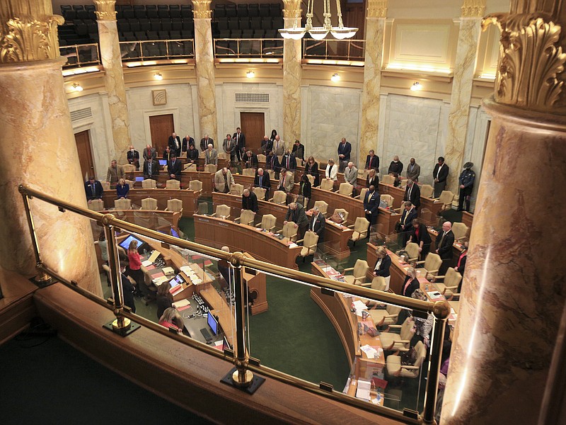 House members stand for the opening prayer Wednesday, April 14, in the House chamber at the state Capitol. (Arkansas Democrat-Gazette/Staton Breidenthal)