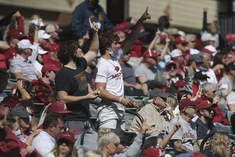 Arkansas fans point Sunday, April 18, 2021, during the fifth inning against Texas A&M at Baum-Walker Stadium in Fayetteville. (NWA Democrat-Gazette/Charlie Kaijo)