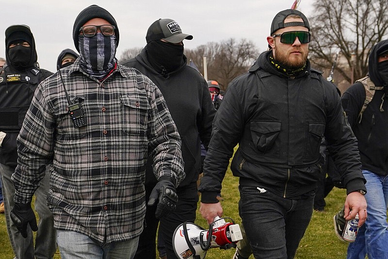 FILE - In this Jan. 6, 2021, file photo, Proud Boys members Joseph Biggs, left, and Ethan Nordean, right with megaphone, walk toward the U.S. Capitol in Washington. (AP/Carolyn Kaster, File)