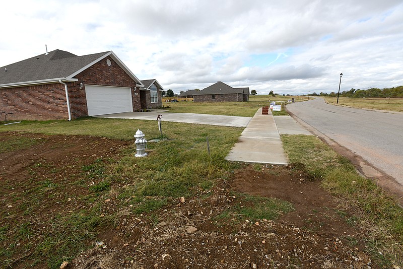 NWA Democrat-Gazette/SPENCER TIREY In a subdivision  on Butterfly Road several newly contracted homes are seen with sidewalk built, Friday, Oct. 23, 2015, in Springdale. The Springdale City Council has given out several waivers in 2015 for residents allowing them not to have to build sidewalks when doing work on their homes. Some questions have been raised to if tax dollars will be used later to building the sidewalk.