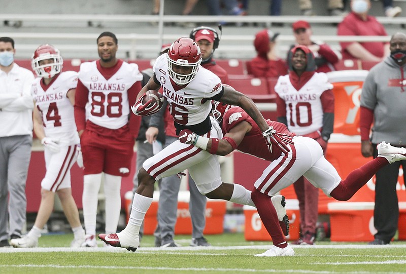 Arkansas wide receiver Treylon Burks (16) carries the ball, Saturday, April 17, 2021 during the first quarter of the Red-White spring football game at Razorback Stadium in Fayetteville. Check out nwaonline.com/210418Daily/ for today's photo gallery. .(NWA Democrat-Gazette/Charlie Kaijo)
