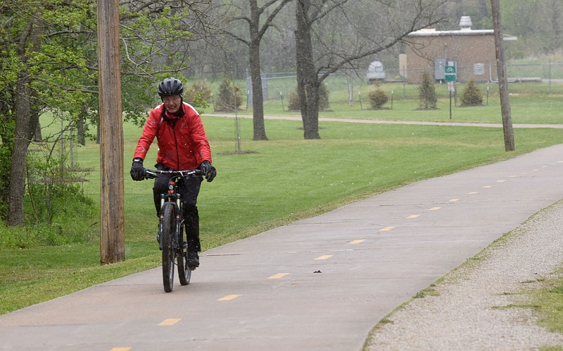 Don Howell bikes during a snow shower on Tuesday April 20 2021 along the Razorback Greenway in Bentonville. Howell and friends are visiting Northwest Arkansas from out of state to bicycle and float the Buffalo National River. Go to nwaonline.com/210421Daily/ to see more photos.
(NWA Democrat-Gazette/Flip Putthoff)