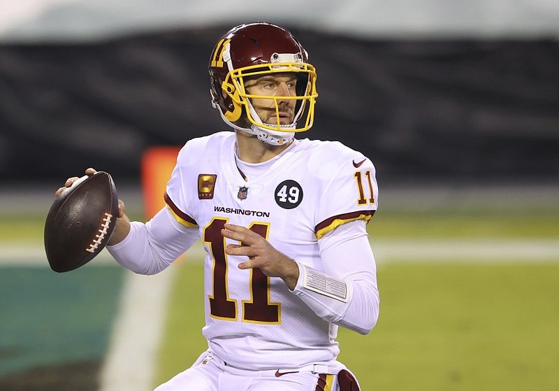 Washington Football Team quarterback Alex Smith (11) is shown in action against the Philadelphia Eagles during an NFL game in Philadelphia on Jan. 3. Smith announced his retirement Monday on Instagram, saying he still has plenty of snaps left him just shy of his 37th birthday but is calling it quits to enjoy time with his family.
