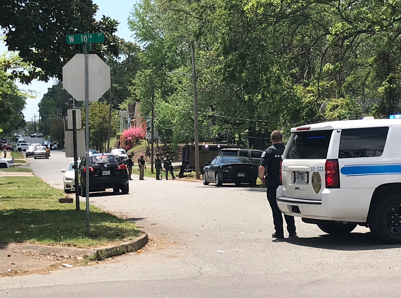Officers work outside a North Little Rock home where police said a person was barricaded on Tuesday. (Arkansas Democrat-Gazette/Tommy Metthe)