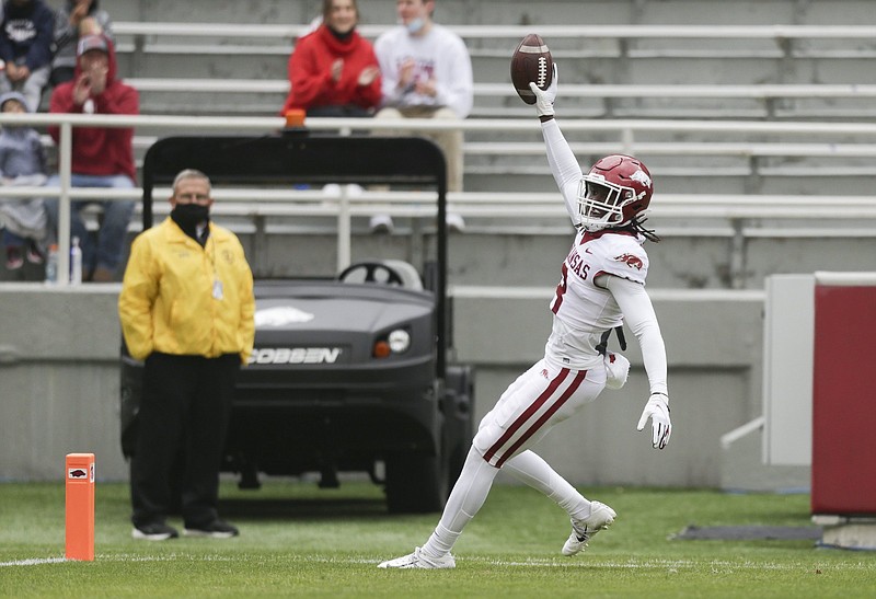 Arkansas wide receiver Mike Woods (8) scores a touchdown, Saturday, April 17, 2021 during the first quarter of the Red-White spring football game at Razorback Stadium in Fayetteville. Check out nwaonline.com/210418Daily/ for today's photo gallery. .(NWA Democrat-Gazette/Charlie Kaijo)