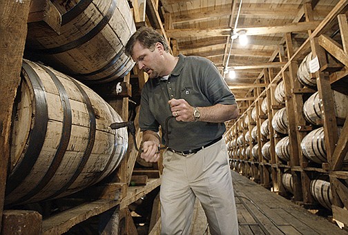 Jeff Arnett, then-master distiller at the Jack Daniel’s distillery in Lynchburg, Tenn., drills a hole in a barrel of whiskey in this file photo. Arnett is part of the team that’s opening Company Distilling.
(AP)