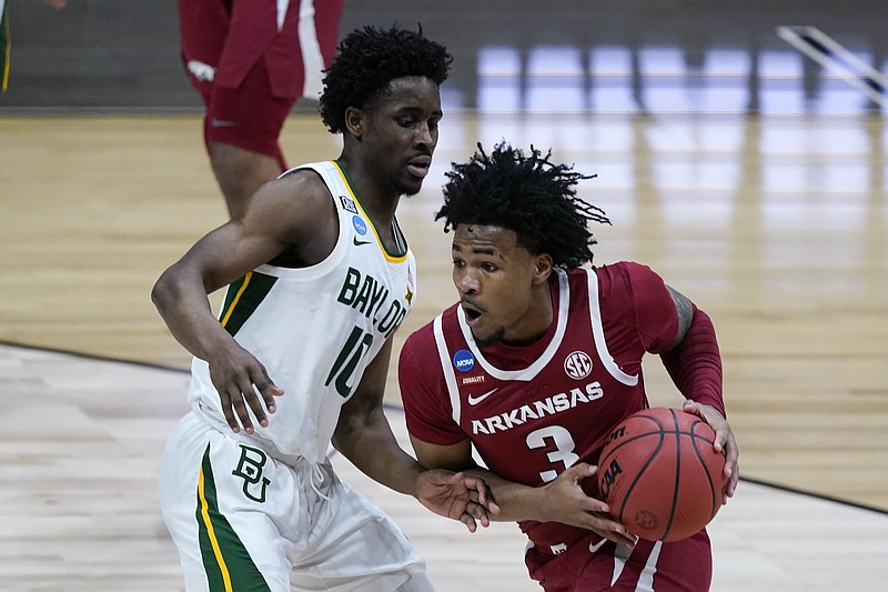 Arkansas guard Desi Sills (3) drives past Baylor guard Adam Flagler (10) during the first half of an Elite 8 game in the NCAA men's college basketball tournament at Lucas Oil Stadium, Monday, March 29, 2021, in Indianapolis. (AP Photo/Michael Conroy)