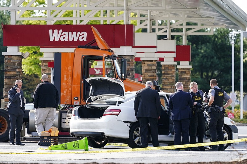 Crime investigators work the scene at a Wawa convenience store and gas station in Breinigsville, Pa., on Wednesday, April 21, 2021. Police converged on the convenience store in eastern Pennsylvania after what state police called a "serious police incident" that closed several businesses and a school. (AP/Matt Rourke)