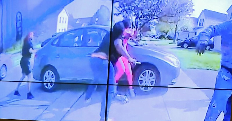 In an image from police bodycam video that the Columbus Police Department played during a news conference Tuesday night, April 20, 2021, a teenage girl, foreground, appears to wield a knife during an altercation before being shot by a police officer Tuesday, April 20, 2021, in Columbus, Ohio. (Columbus Police Department via WSYX-TV via AP)