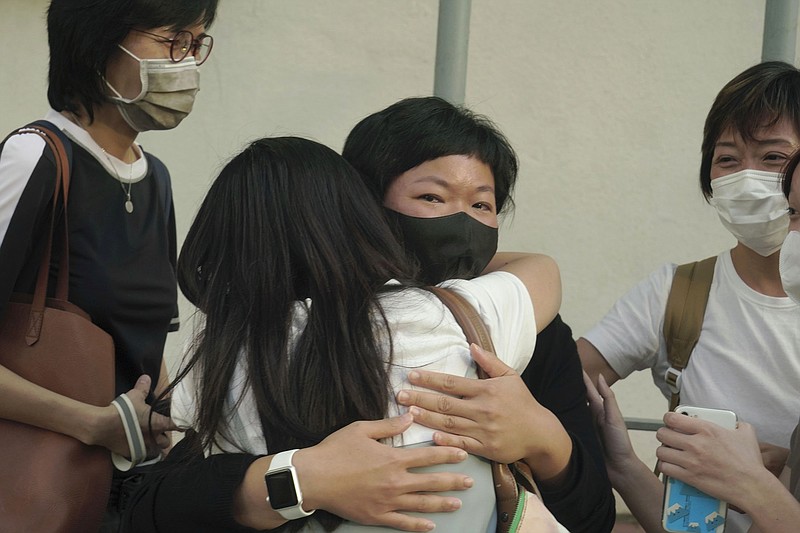 Hong Kong journalist Choy Yuk-ling (center) also known as Bao Choy, is comforted Thursday outside court in Hong Kong after she was fined $775 on a charge of making false statements while obtaining information from a vehicle database as she investigated a 2019 mob attack at a train station.
(AP/Kin Cheung)