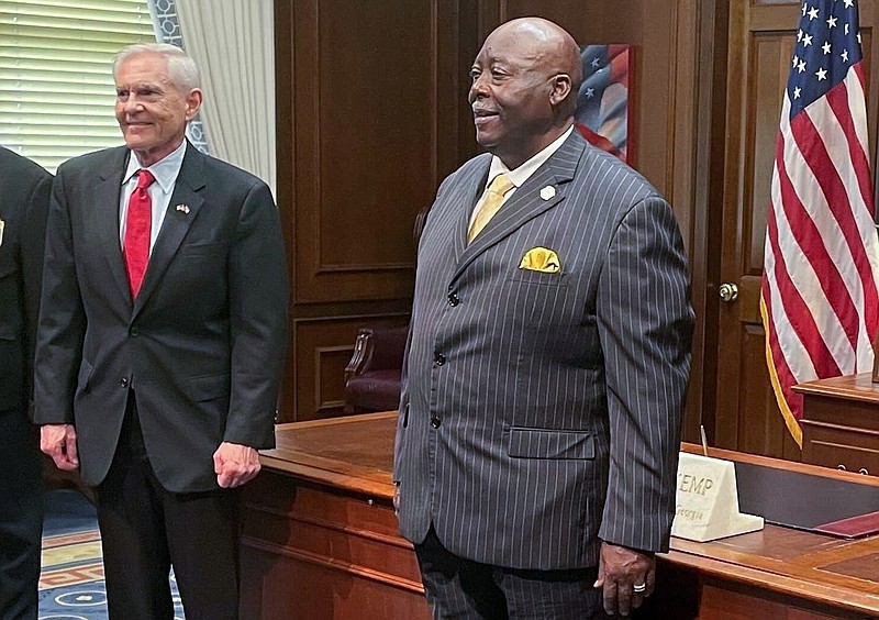 The Rev. Abraham Mosley (right) poses for a photo in the office of Georgia Gov. Brian Kemp after being sworn in as the new board chair for the Stone Mountain Memorial Association on Tuesday, April 20, 2021. At left is memorial association CEO Bill Stephens. (Greg Bluestein/Atlanta Journal-Constitution via AP)
